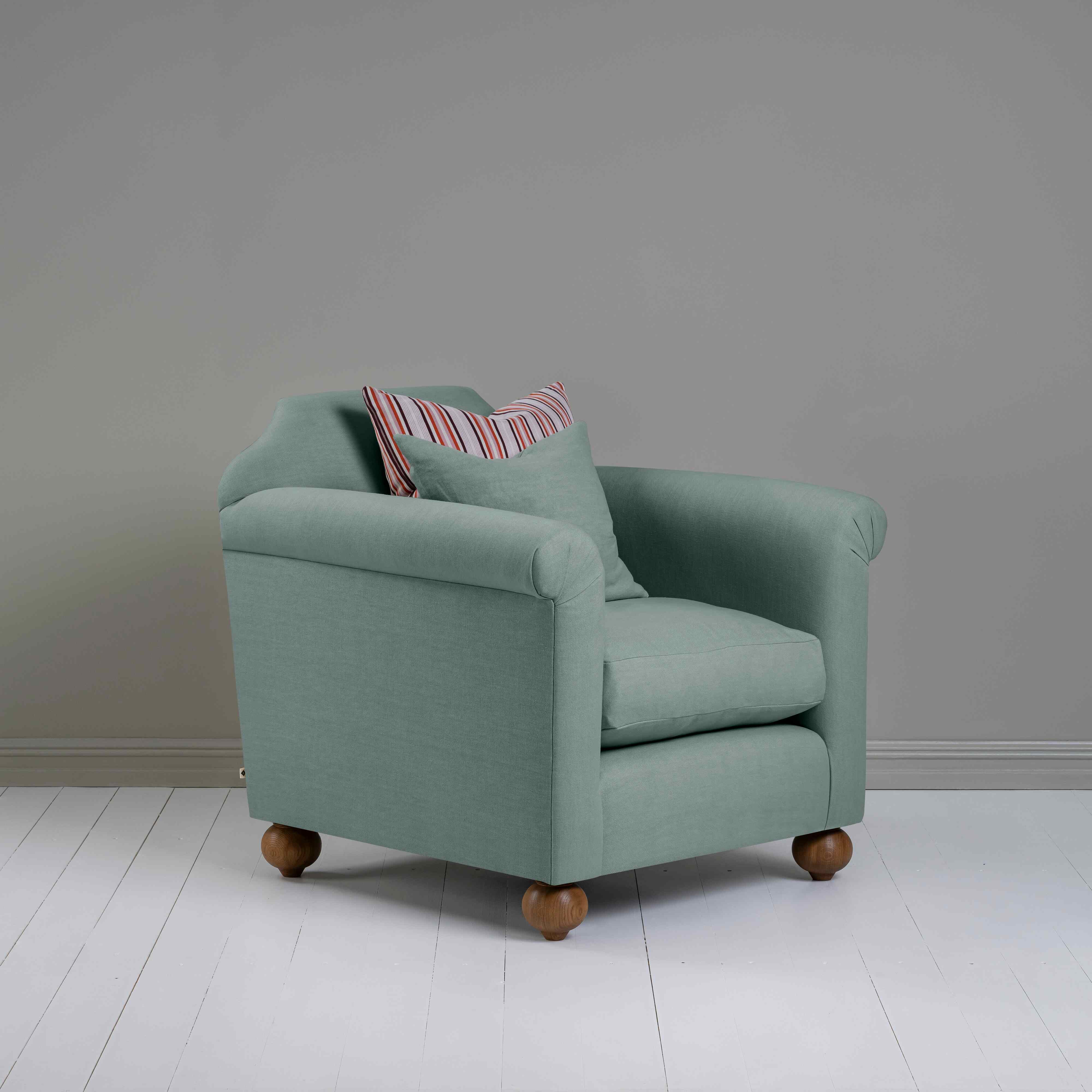  Dolittle Armchair in Laidback Linen Mineral, Side View With 1 Matching and 1 Cotton Cushions - Nicola Harding 