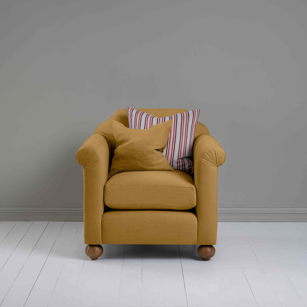  Dolittle Armchair in Laidback Linen Ochre, Front View With 1 Matching and 1 Other Cushion - Nicola Harding 