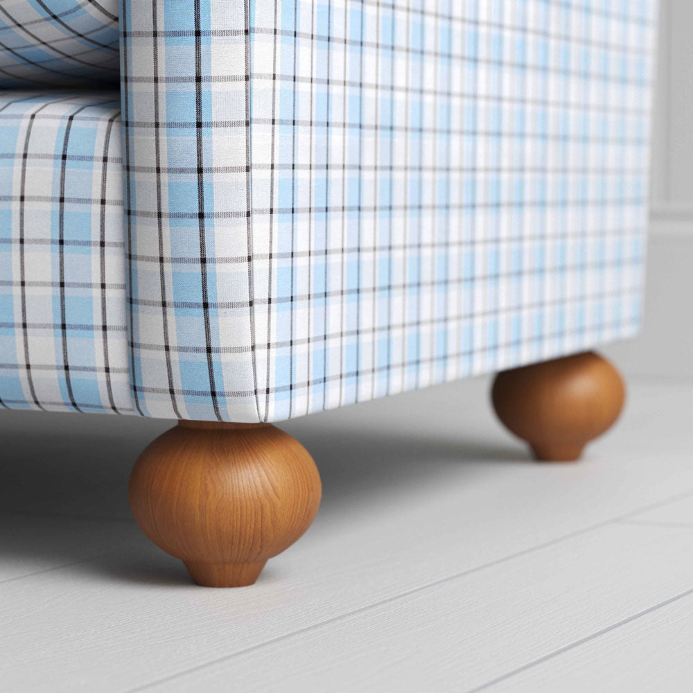  A close-up of a blue and white checkered sofa, showcasing its intricate pattern and inviting texture. 