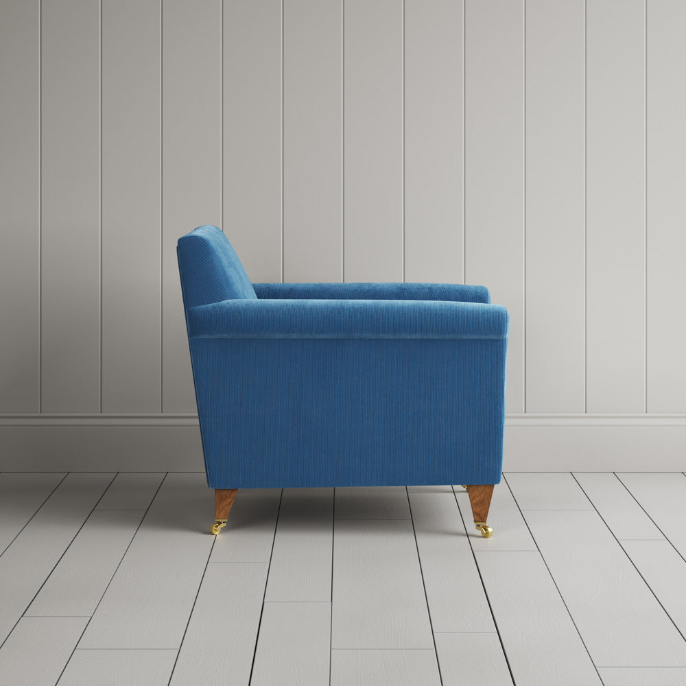 Side profile of the Harbour Blue corduroy Idler armchair, a versatile Edwardian-style occasional chair.