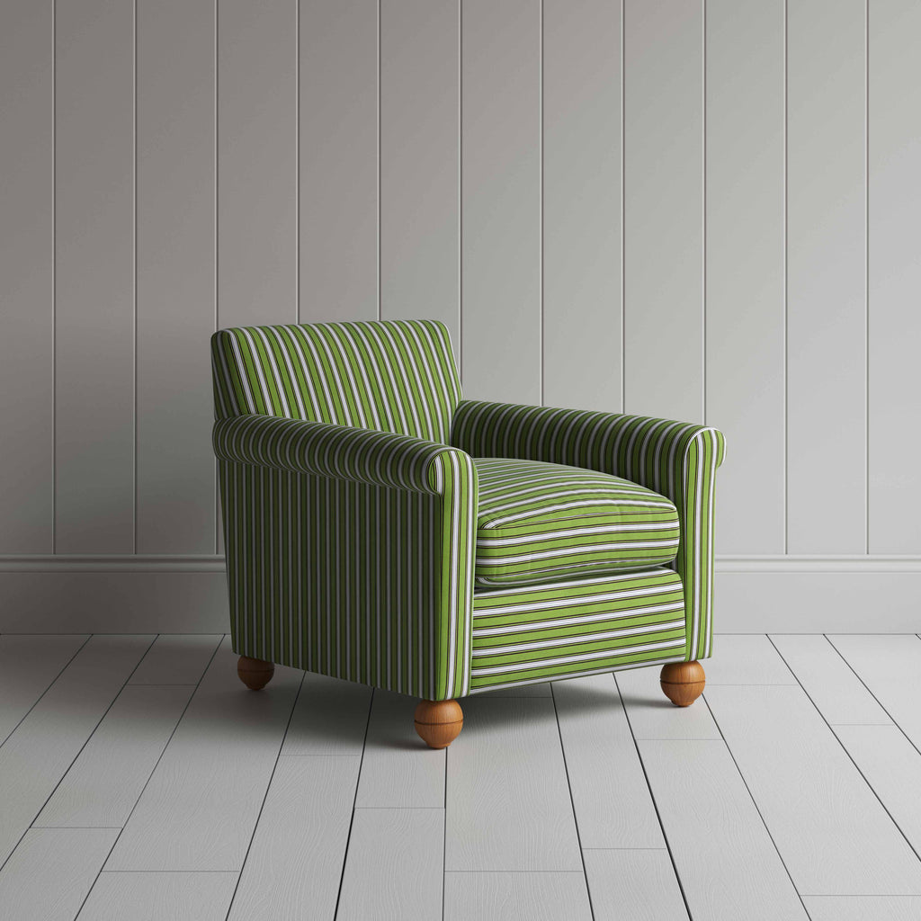  Striped green and white sofa by a wall. 