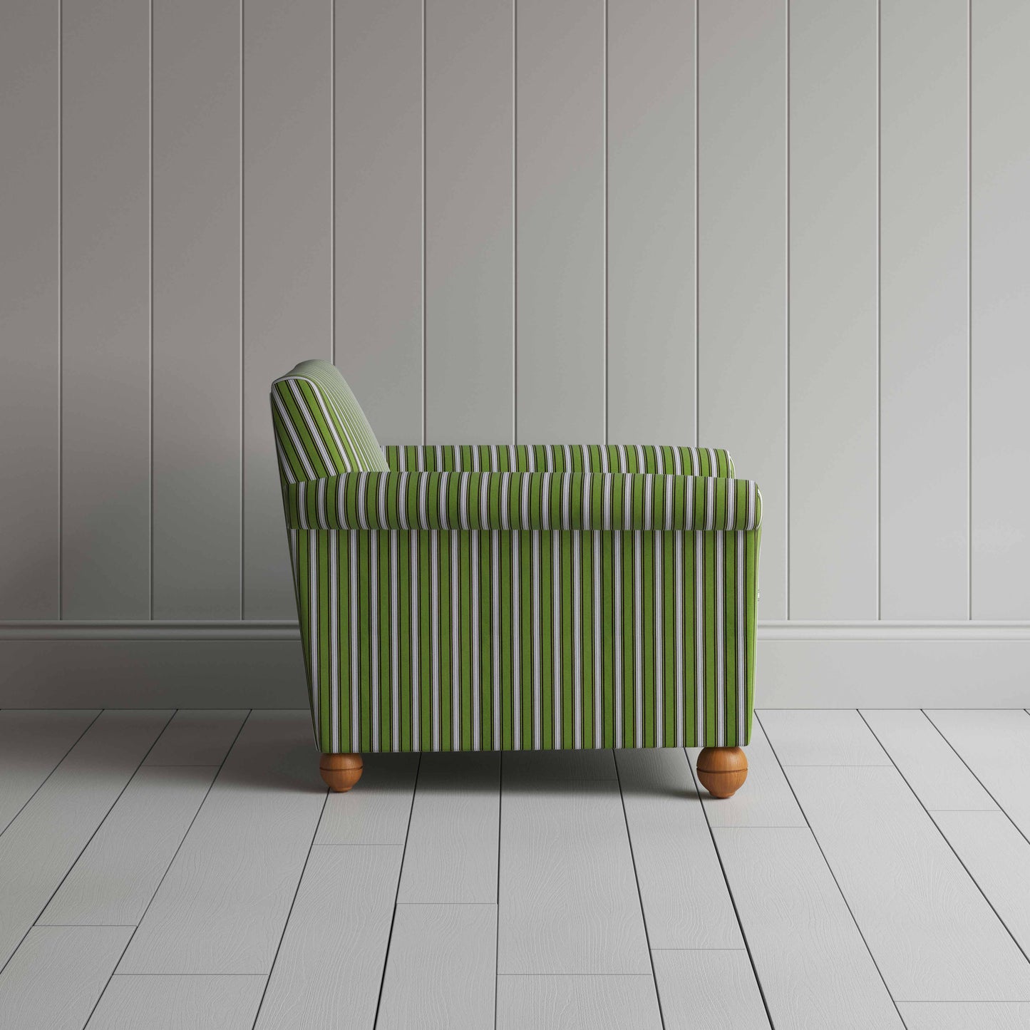 Striped green and white couch by a wall.