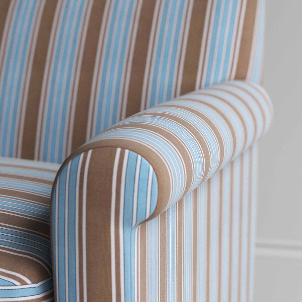 A close-up of a blue and white striped chair, adding a touch of elegance and style to any room.