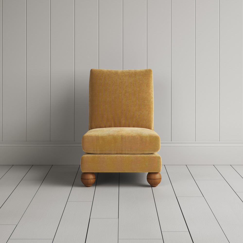  Front view of the Perch armchair in Wheat corduroy, a bespoke chair perfect for a reading nook. 