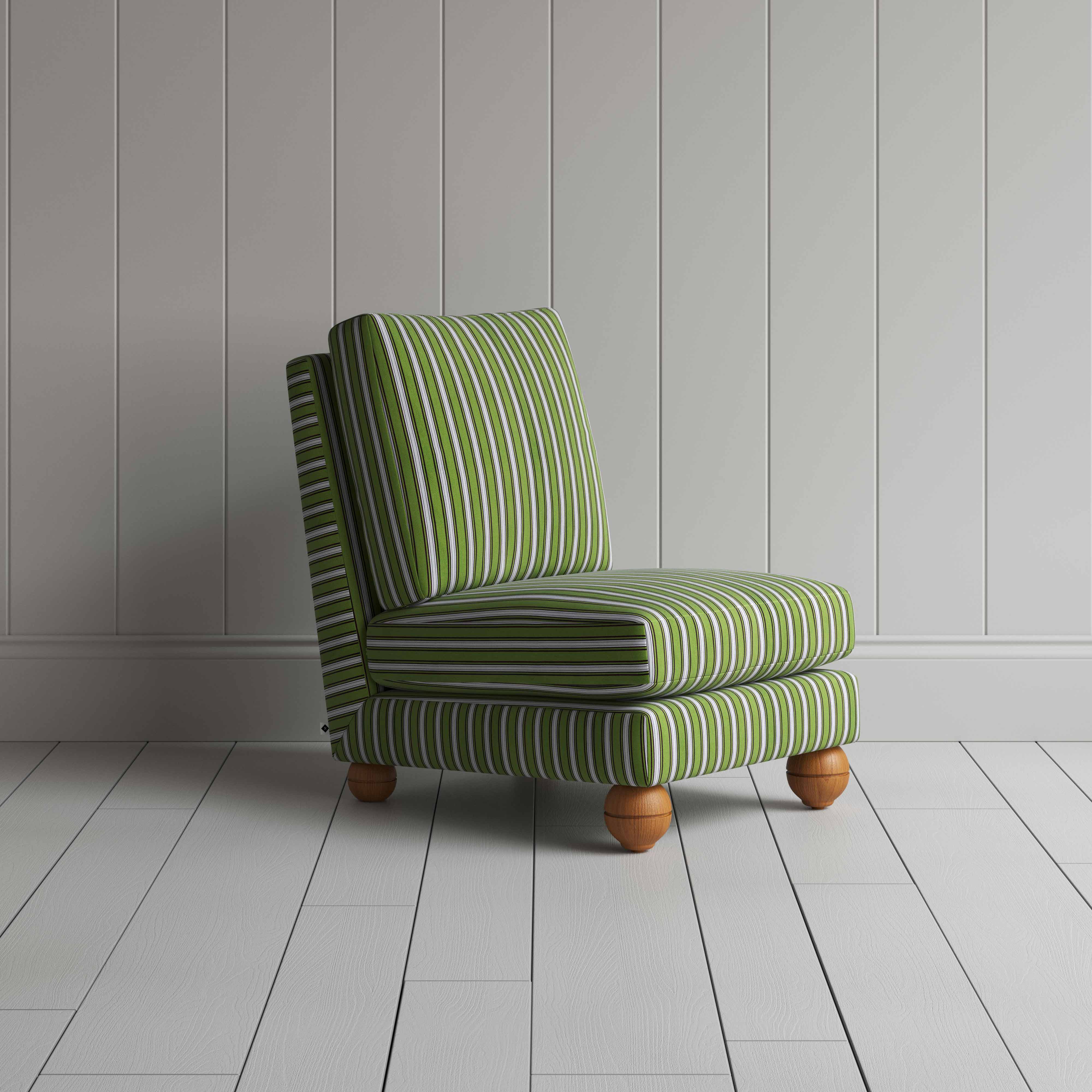  A green and white striped couch placed in front of a wall. 