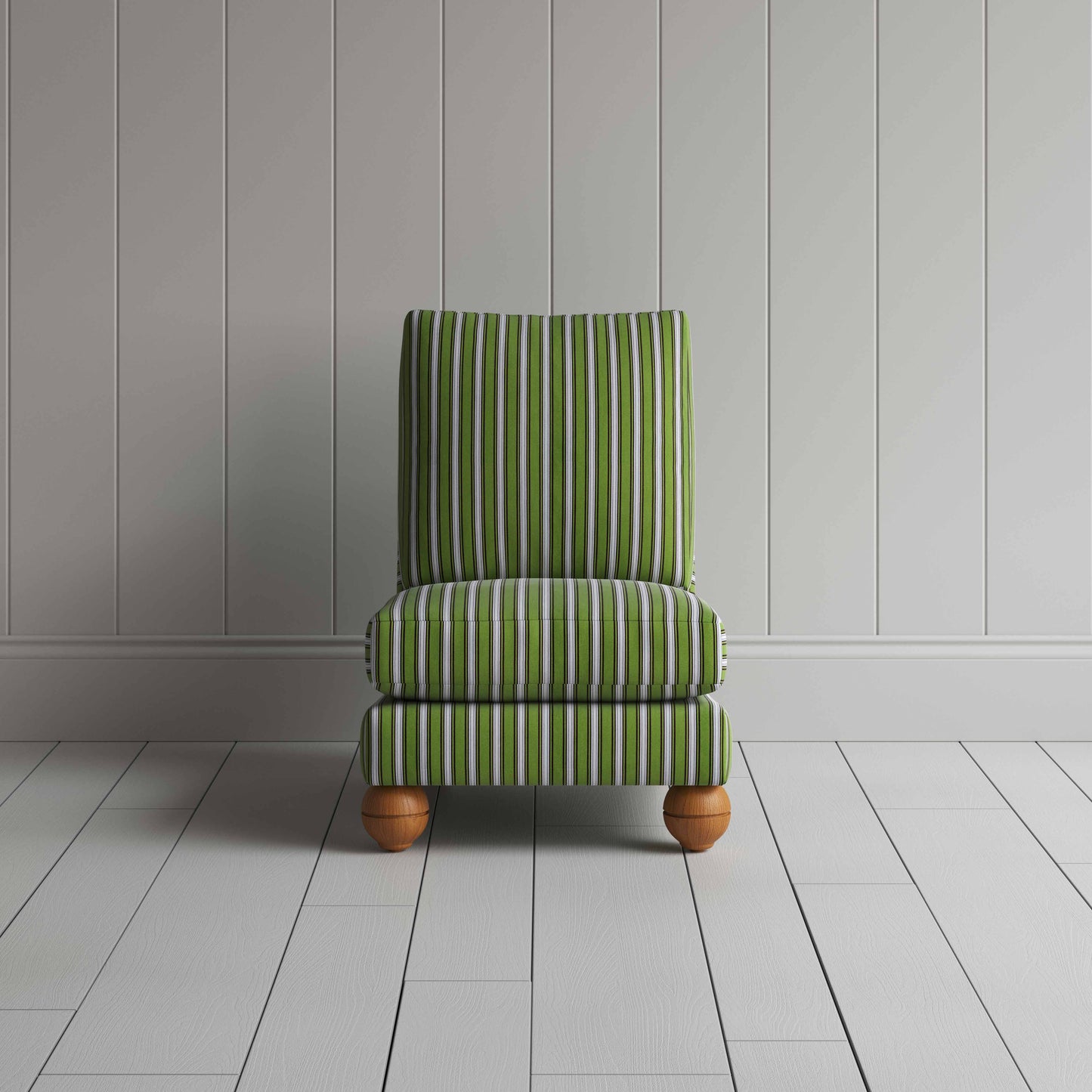 A green and white striped couch placed in front of a wall.