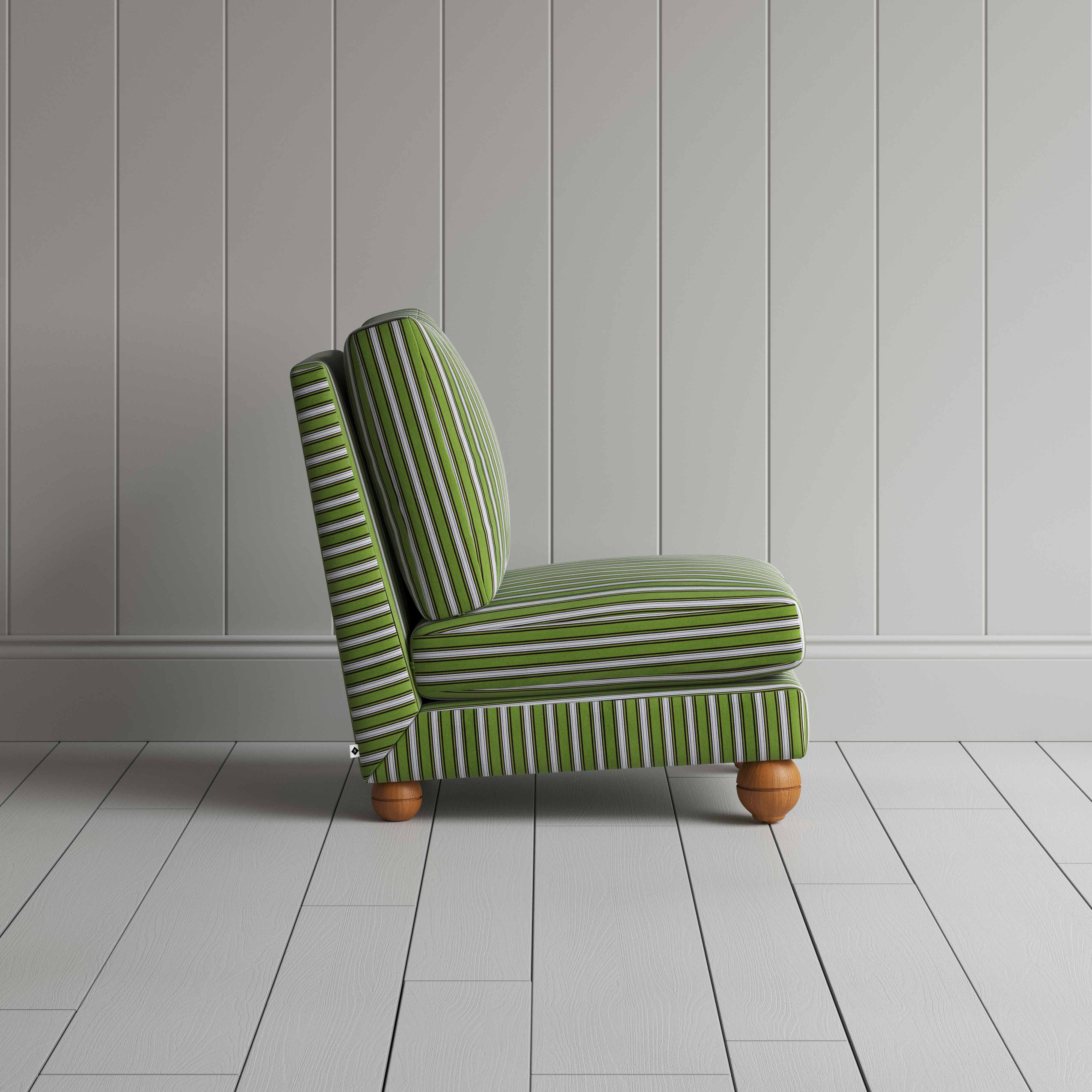  A green and white striped couch placed in front of a wall. 