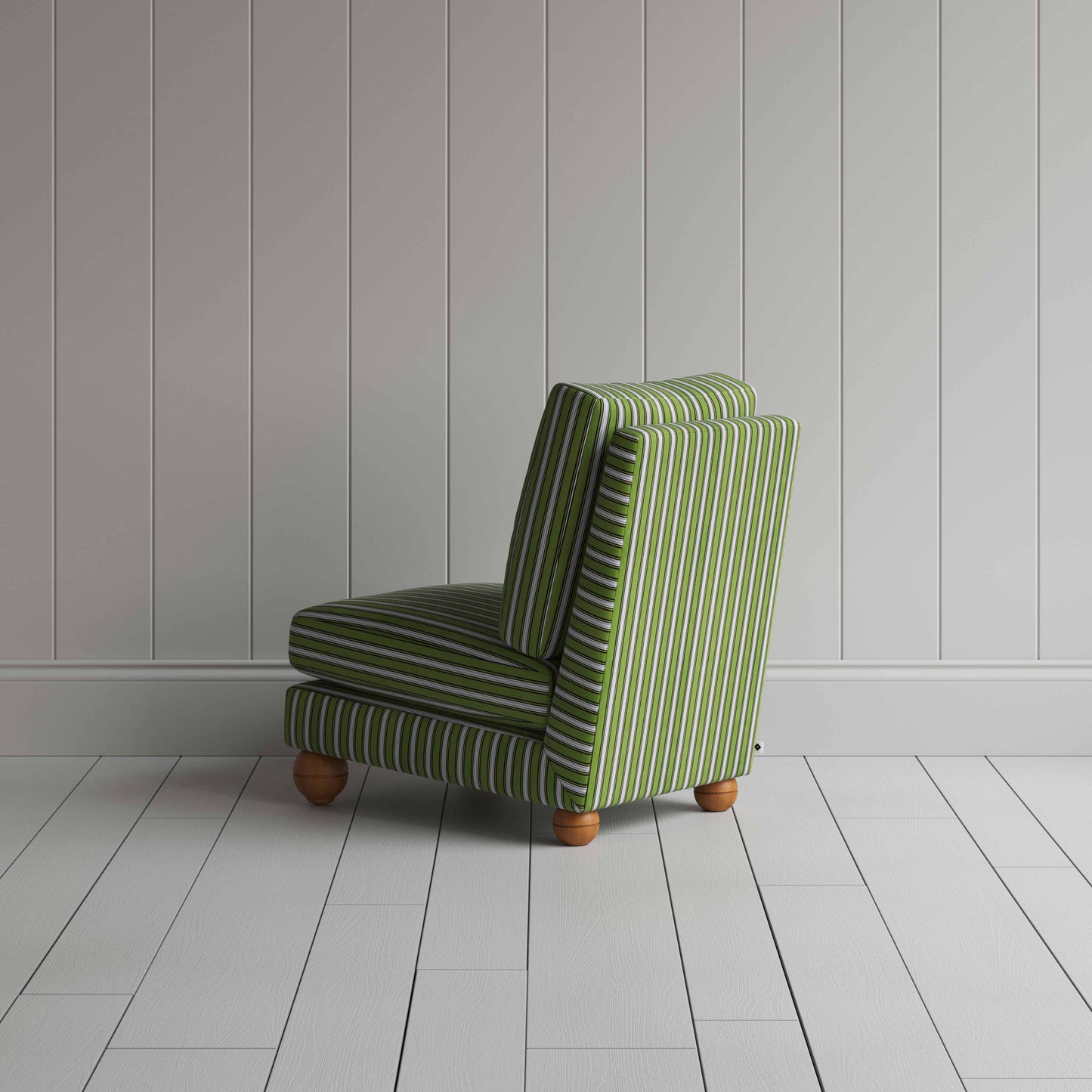 A green and white striped couch placed in front of a wall.