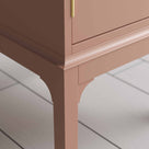  Edge Design close up of a small pink bedside table with a side door, perfect for storing items  