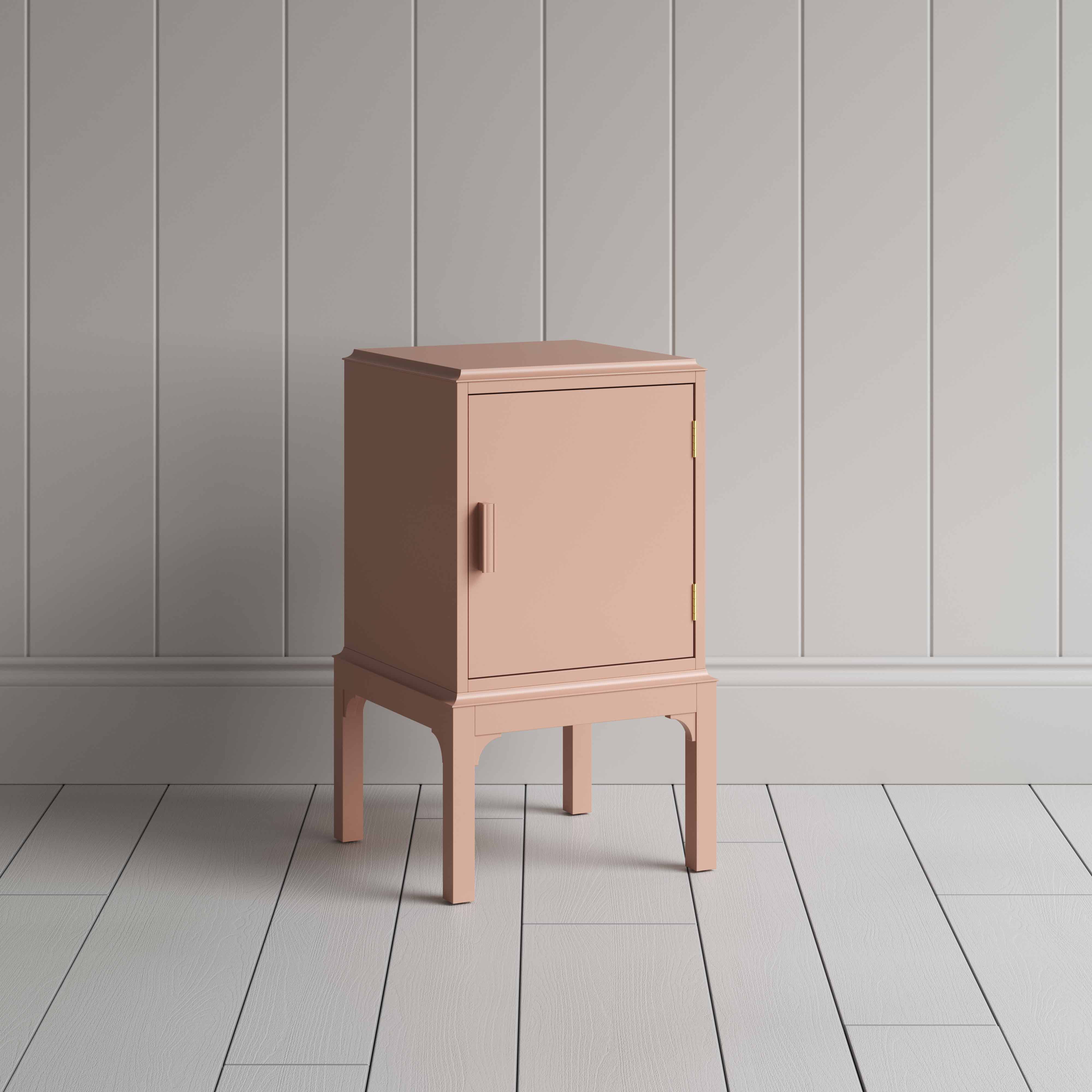  A small pink bedside table with a side door, perfect for storing items discreetly and adding a pop of color to any room. 