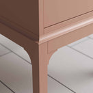  Leg Design close up of small pink bedside table with a side door, perfect for storing items  