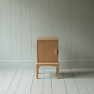  Front View of Bits and Bobs Bedside Table, Natural Oak, Left Hand Side - Nicola Harding 
