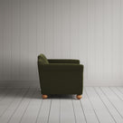 Compact side profile of a luxury green velvet love seat by Nicola Harding.