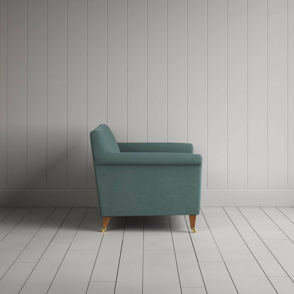 Profile view of the handcrafted Mineral linen love seat by Nicola Harding.