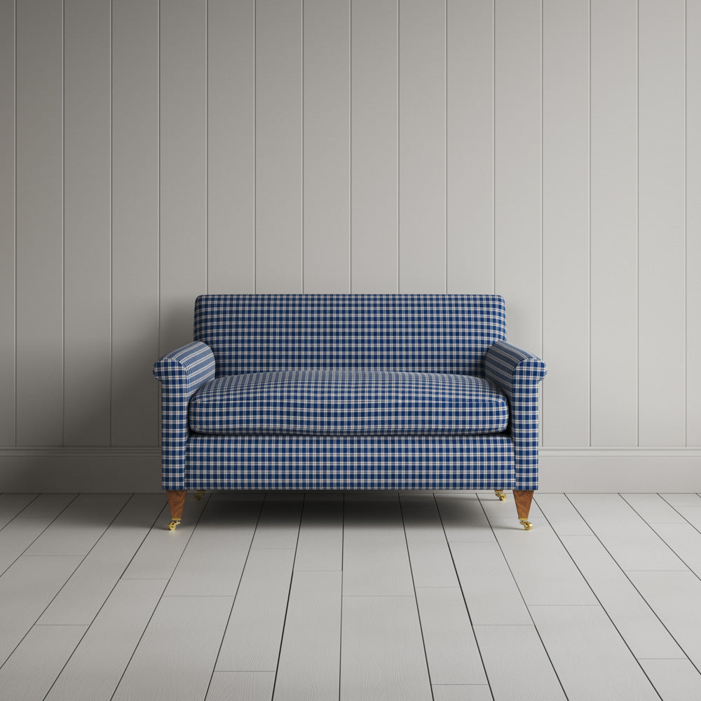  Front view of the Idler love seat in blue and brown plaid cotton with an Edwardian silhouette. 