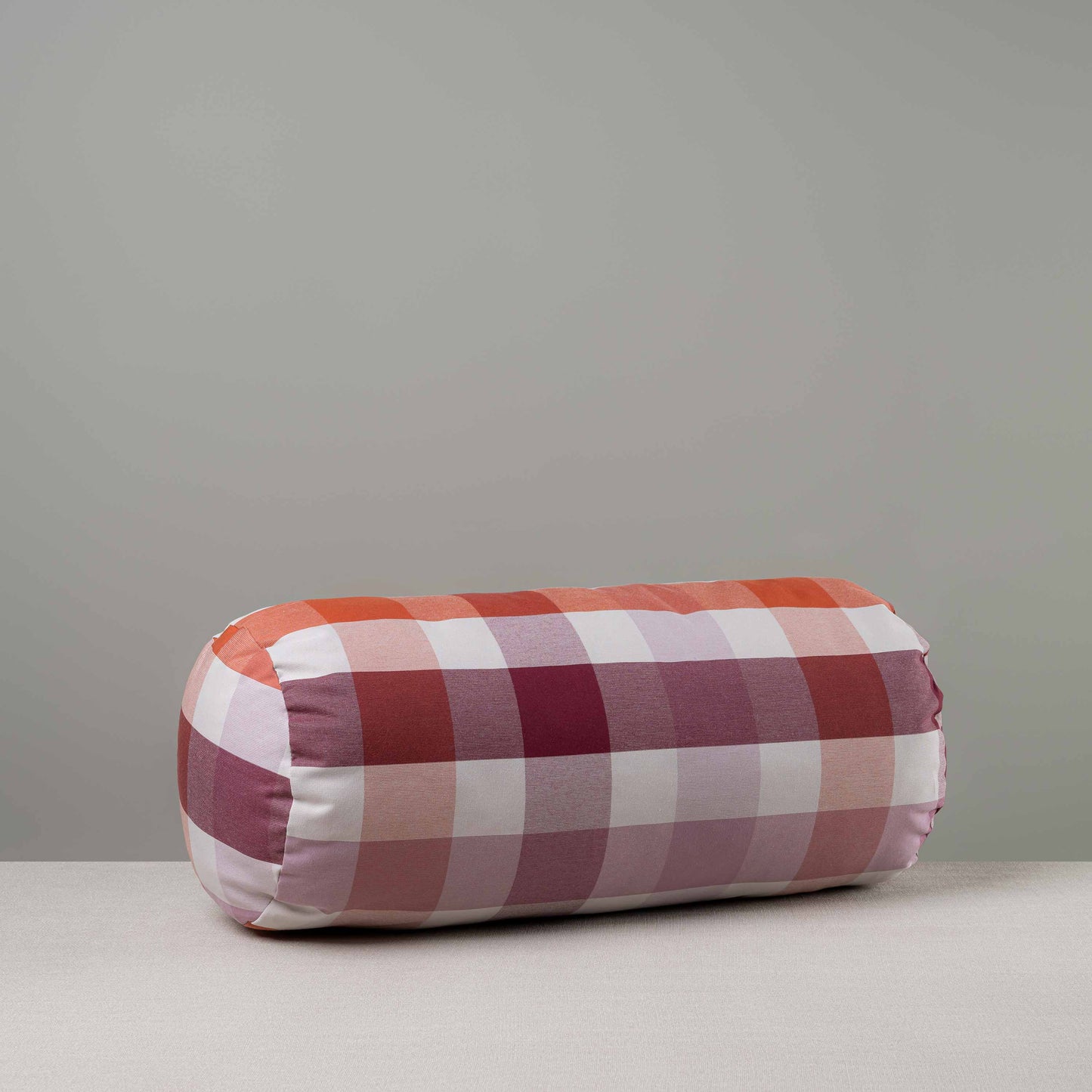 Bask Bolster Cushion in Checkmate Cotton, Berry - Nicola Harding