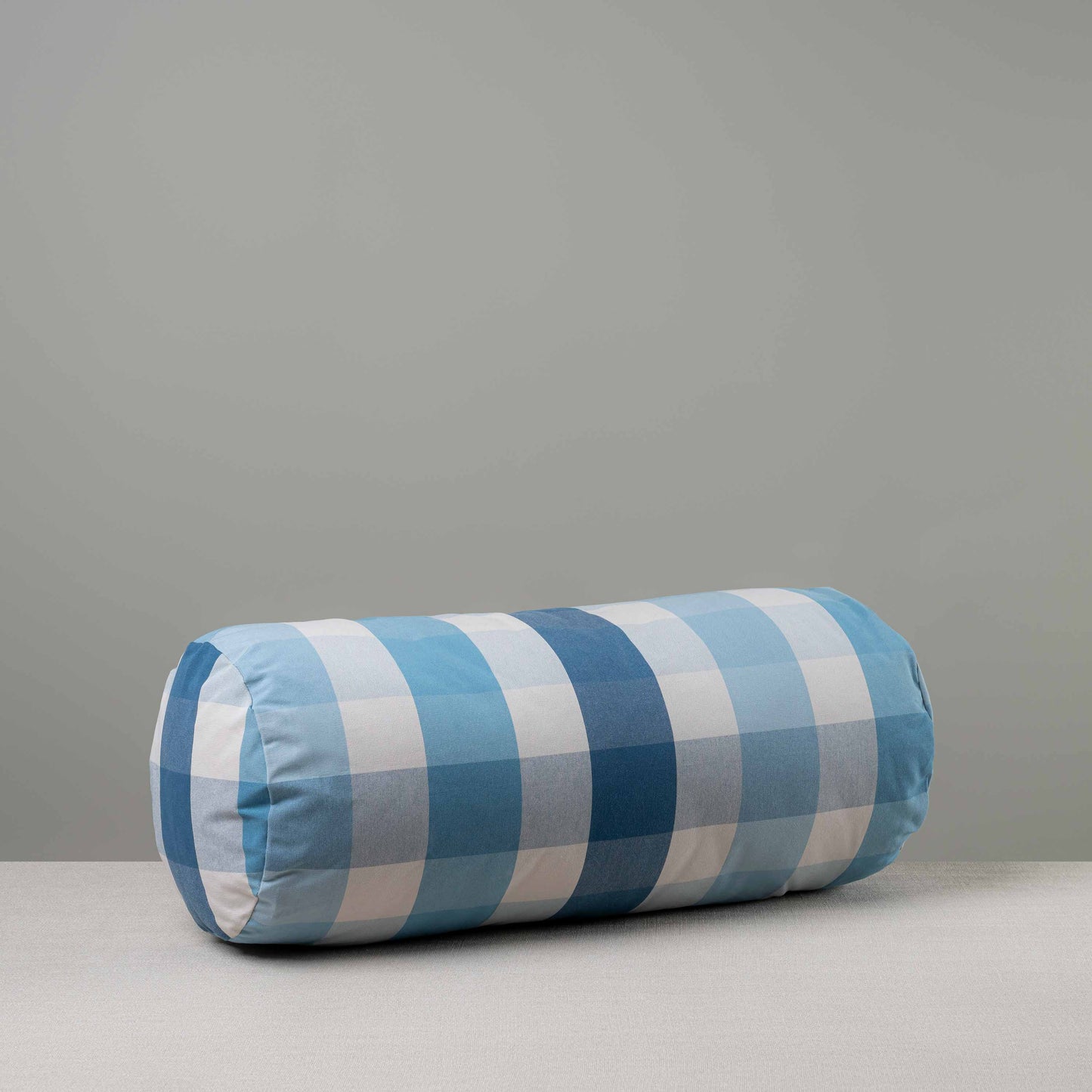 Bask Bolster Cushion in Checkmate Cotton, Blue - Nicola Harding