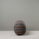  Side View of Bask Bolster Cushion in Regatta Cotton, Charcoal - Nicola Harding 