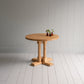 Beautiful small round dining table with three plants on it, manufactured by NiX by Nicola Harding & Co.