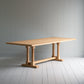 Side tilt view of the Tuck In rectangular dining table in oak, manufactured by NiX.

