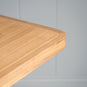  Close-up of the neat edge design on the Tuck In rectangular dining table in oak, designed and manufactured by NiX.
 