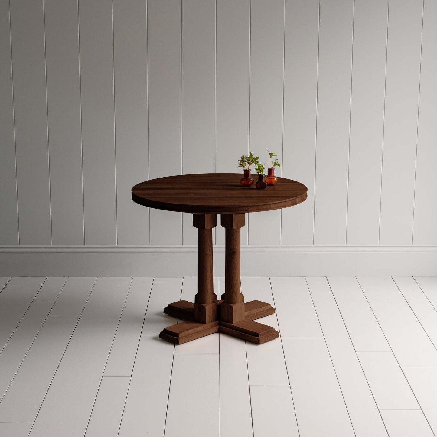 Small beautiful round Smoky Stained Oak Wood dining table, With plants manufactured by NiX in London.