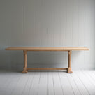  Side view of the Tuck In dining table in lacquered oak. 