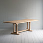  Side tilt view of the Tuck In dining table in lacquered oak.
 