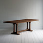  Side tile view of Tuck In rectangular dining table in smoky stained oak wood, by NiX. 
