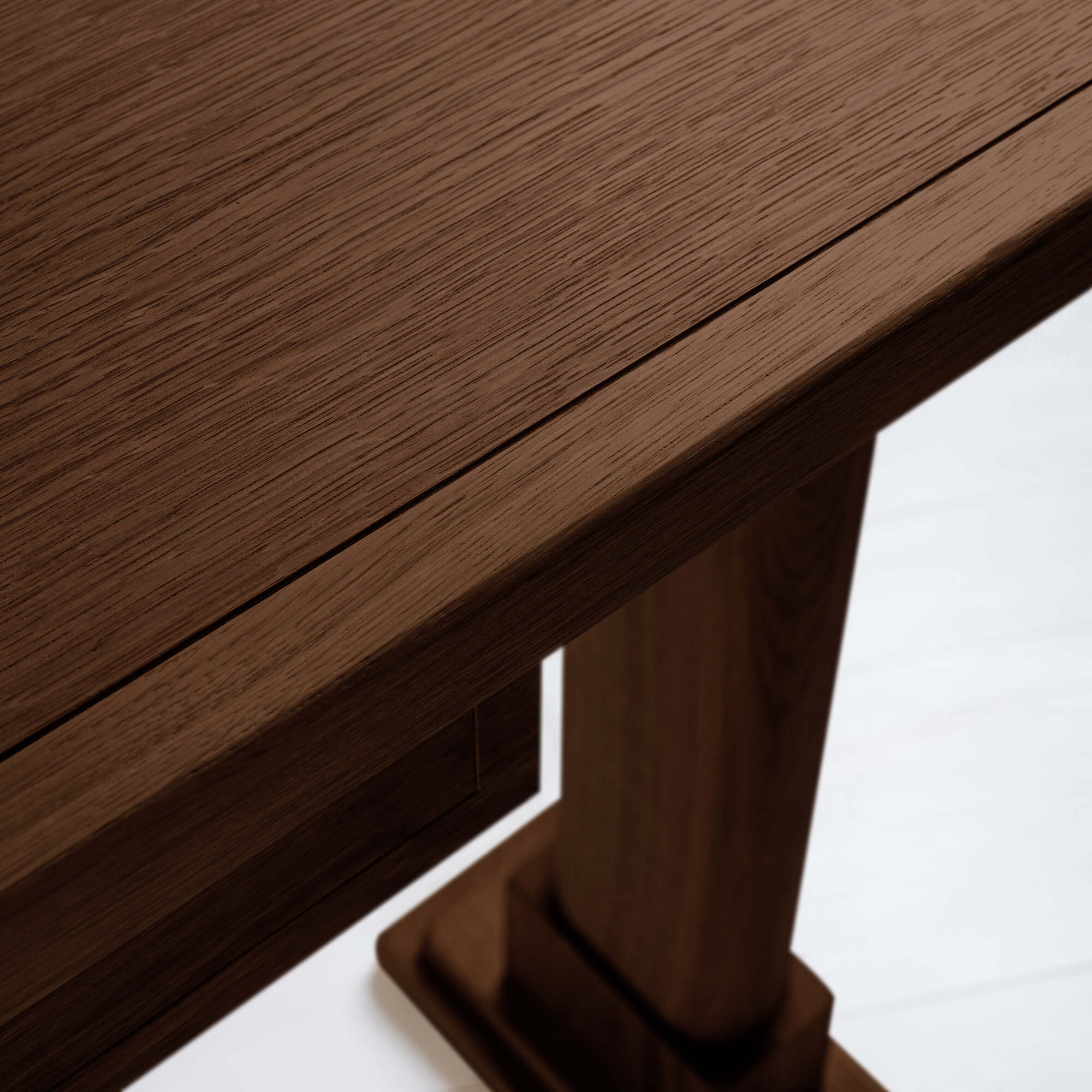  Shelf edge design of a smoky stained oak console table, highlighting the smooth finish and craftsmanship. 