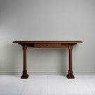  Console Table with a drawer in smoky stained oak, placed against the wall. 