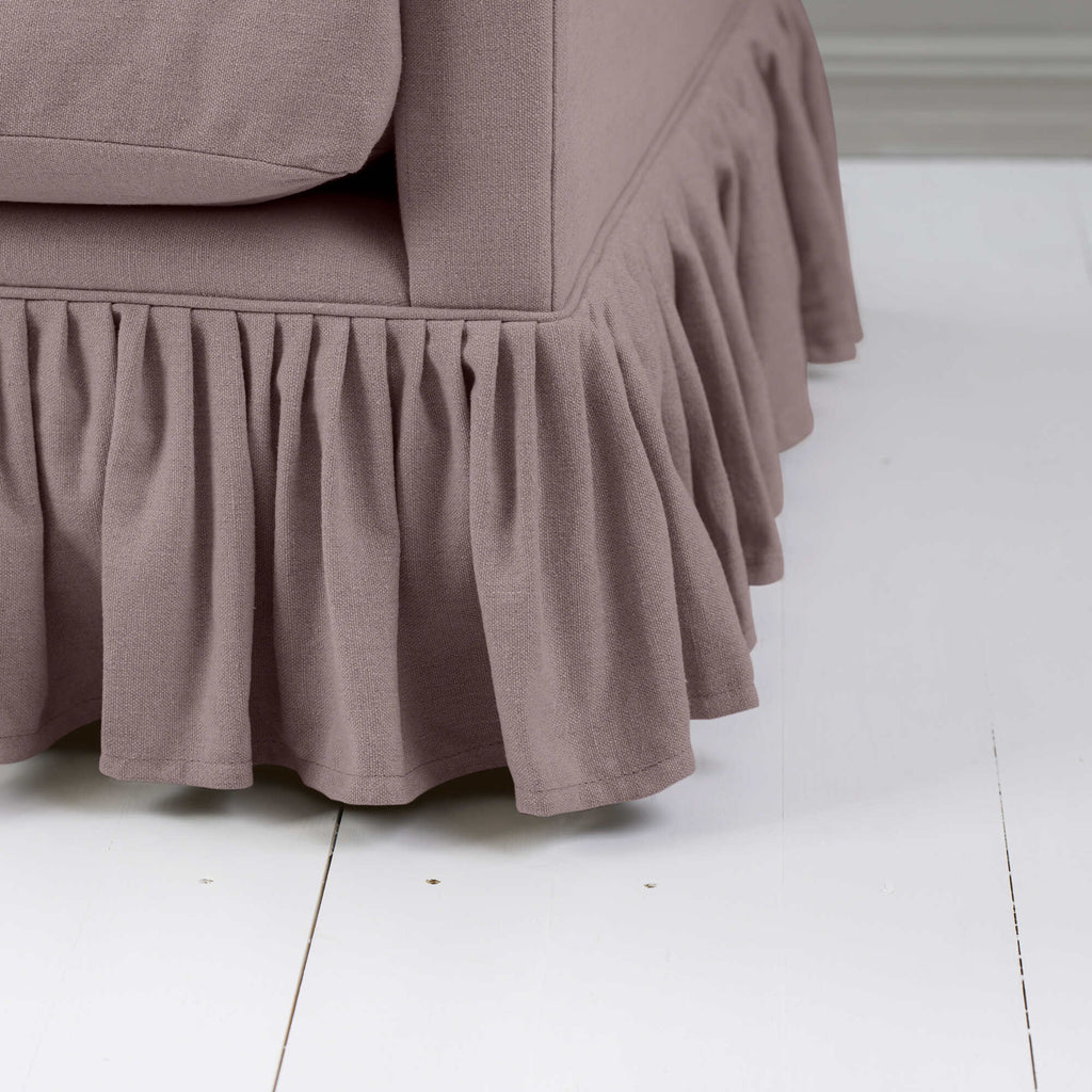  Detailed view of couch featuring ruffled skirt. 