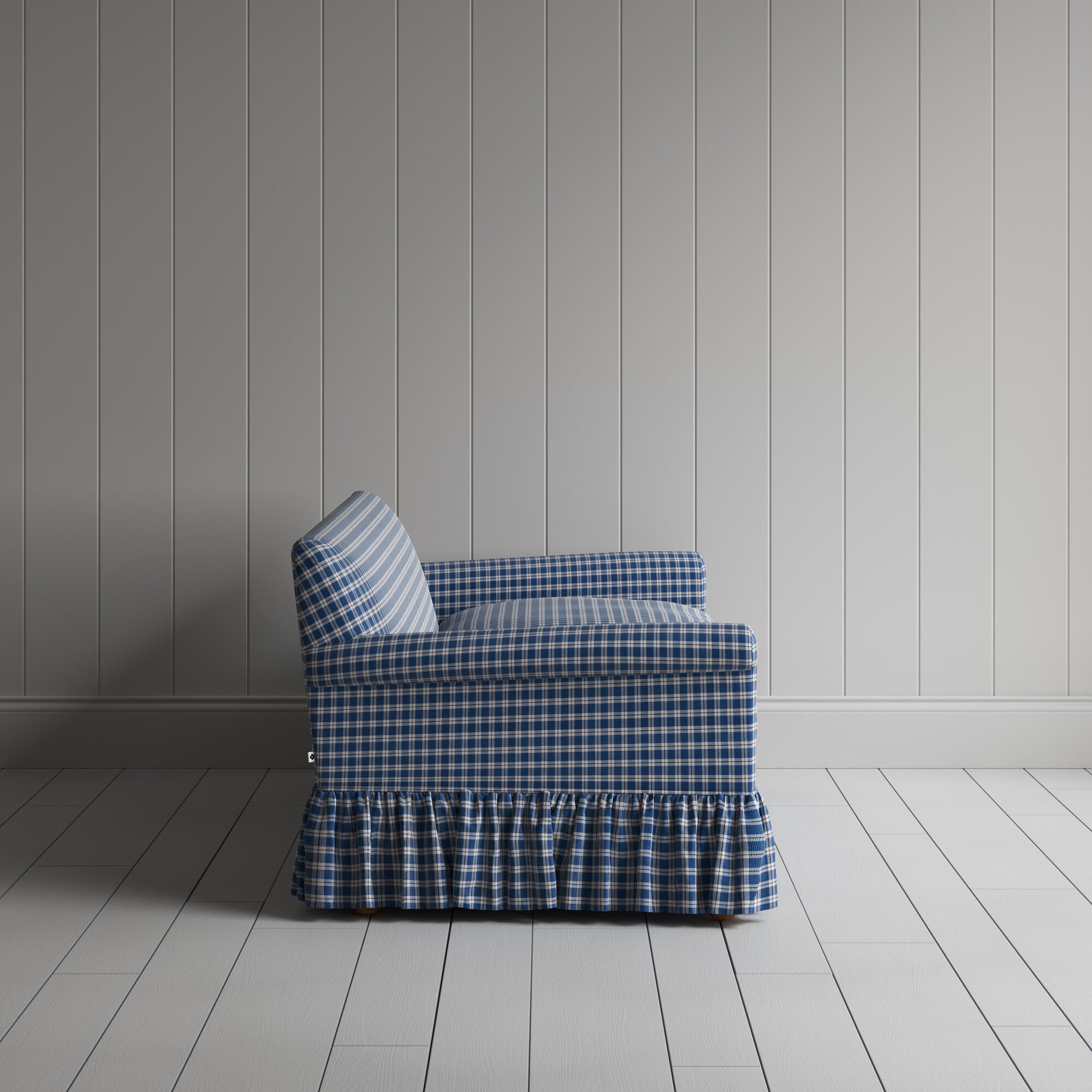  Elegant blue and white checkered sofa featuring a stylish ruffled skirt for a classic touch. 