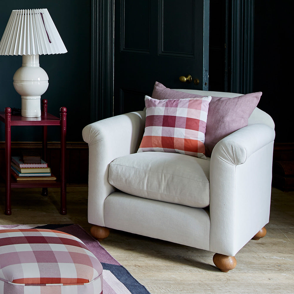 Dolittle Armchair With 2 Cushions, an Ottoman, and a Red Side Table With a White Base Lamp - By NiX