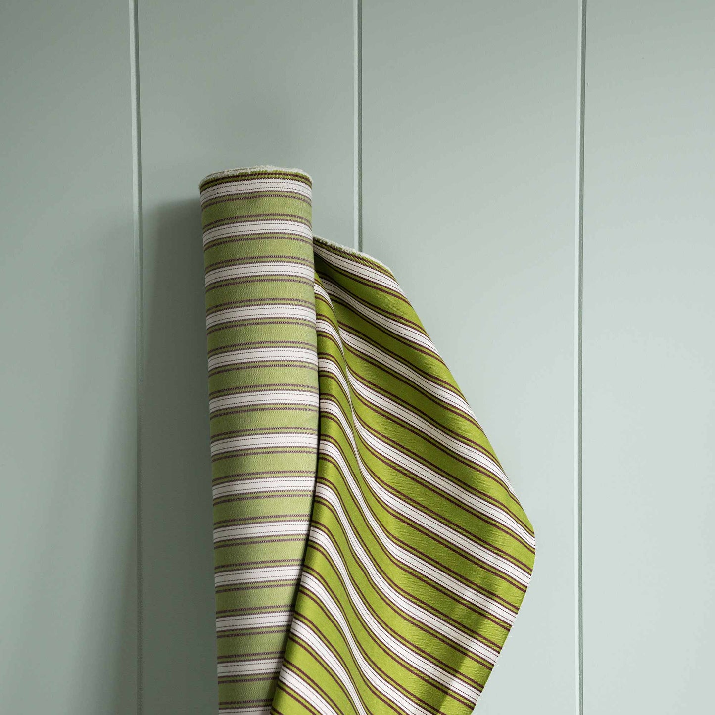 A striped fabric in green and white, adding a touch of color and texture to the space.