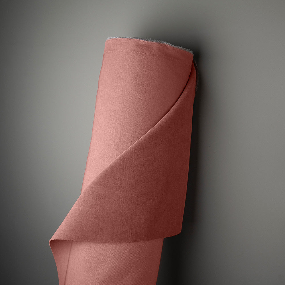 Pink fabric roll on gray background