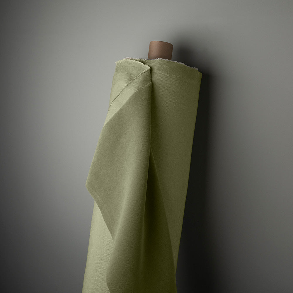 Rolled green velvet cloth hanging on the wall, adding color and texture to the room decor.