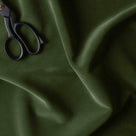  A pair of scissors for cutting green fabric. 