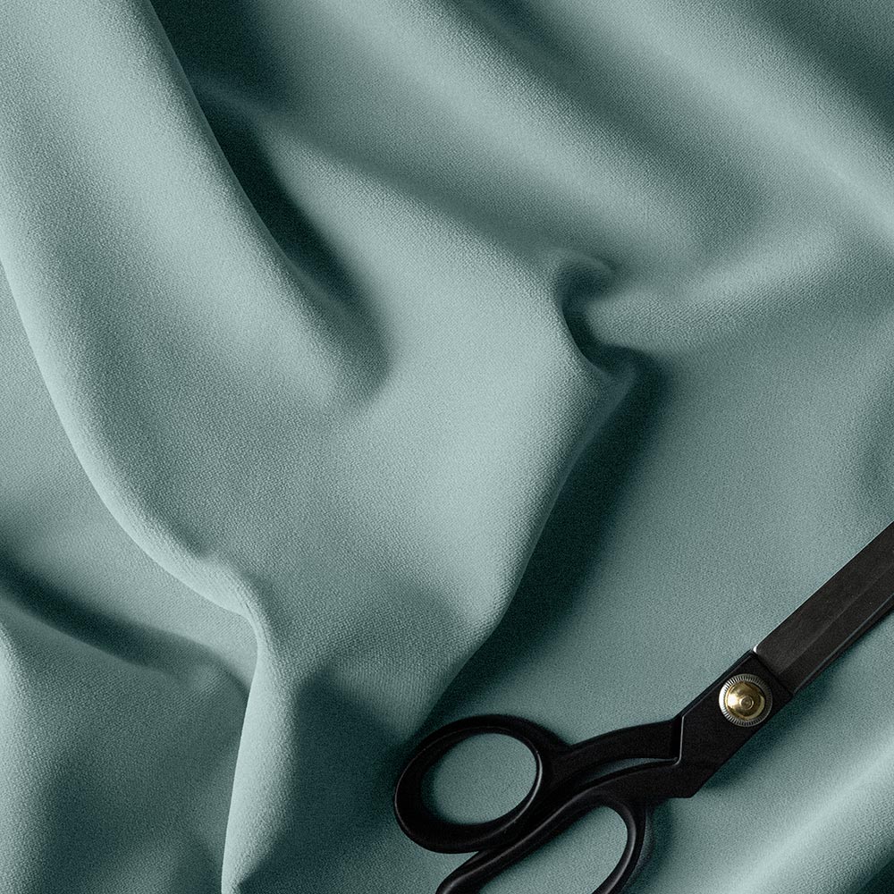  A pair of scissors on a blue fabric. 