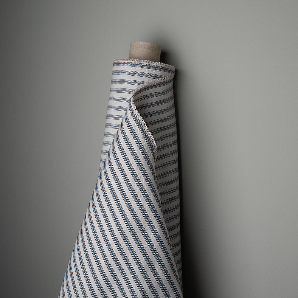  A striped fabric in white and grey colors. 