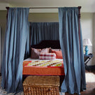  The Folly four-poster bed with bed curtains, mattress, pillows, side table with blue base lamp - NiX by Nicola Harding 