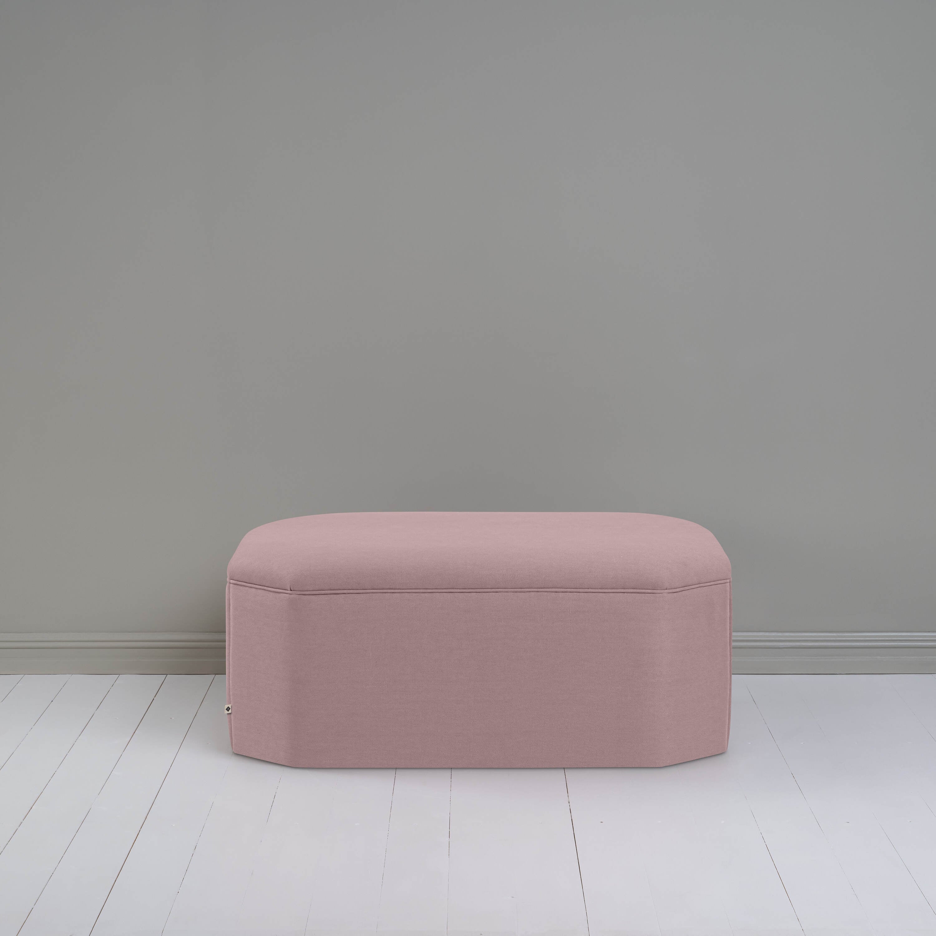  A small ottoman, perfect for adding a touch of color and comfort to any room. 