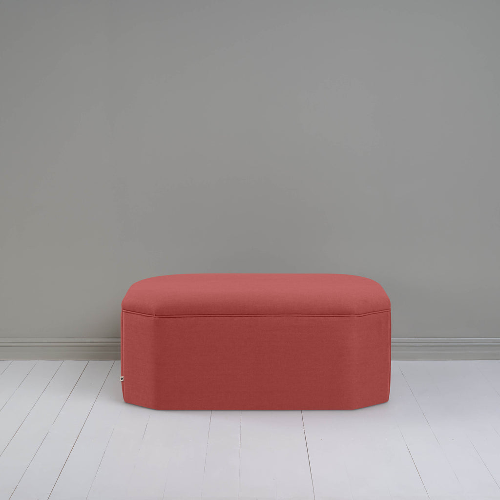  A small red ottoman, perfect for adding a touch of color and comfort to any room. 