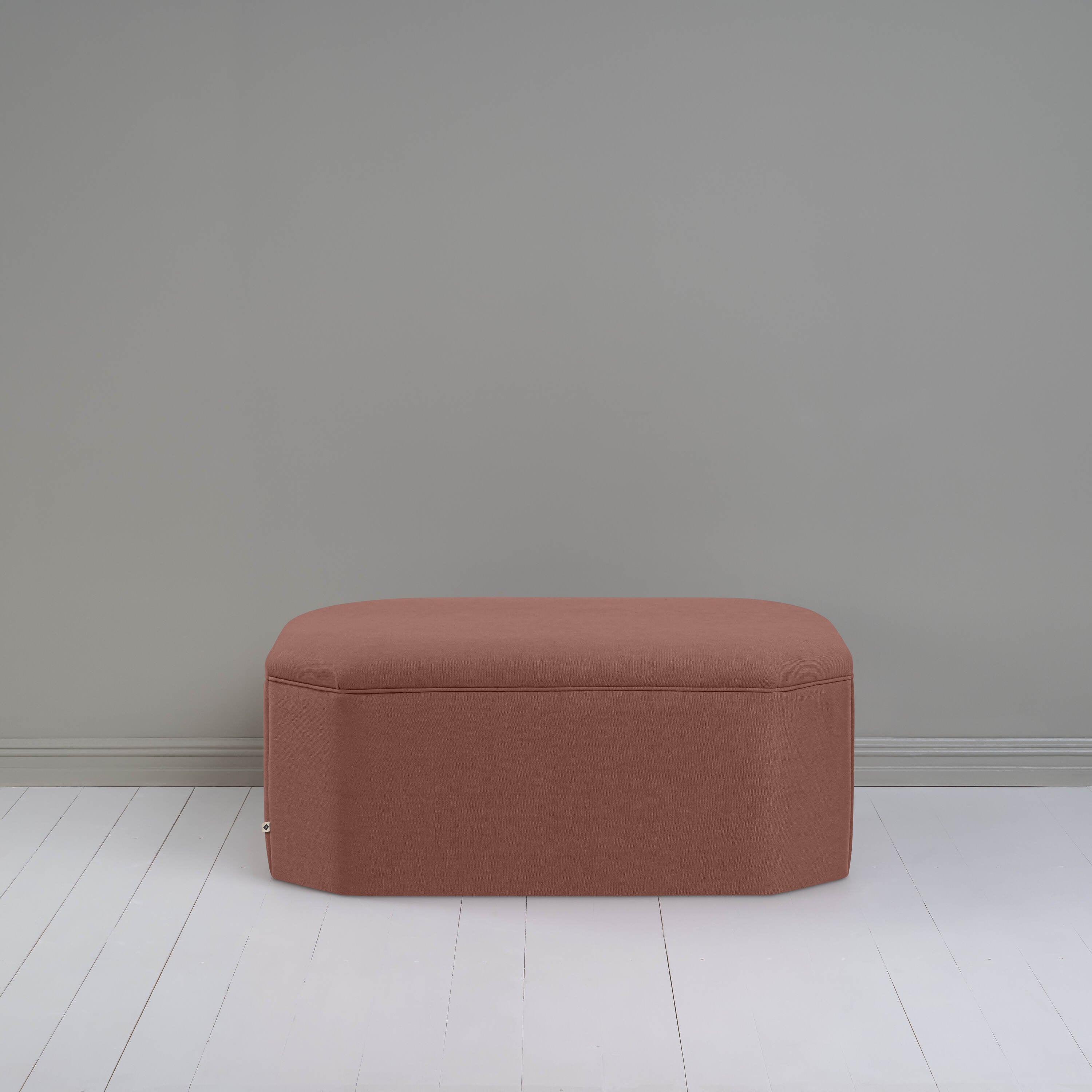  A small brown ottoman, perfect for adding a touch of color and comfort to any room. 