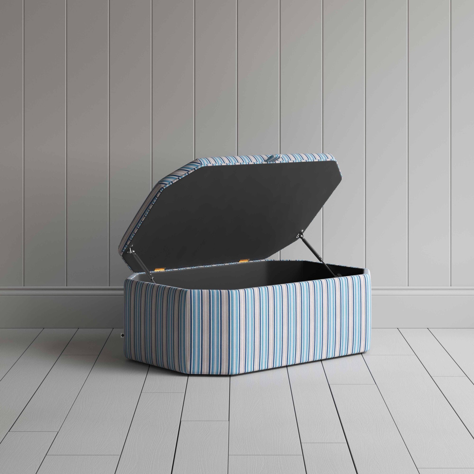  Blue and white striped ottoman on wooden floor. 