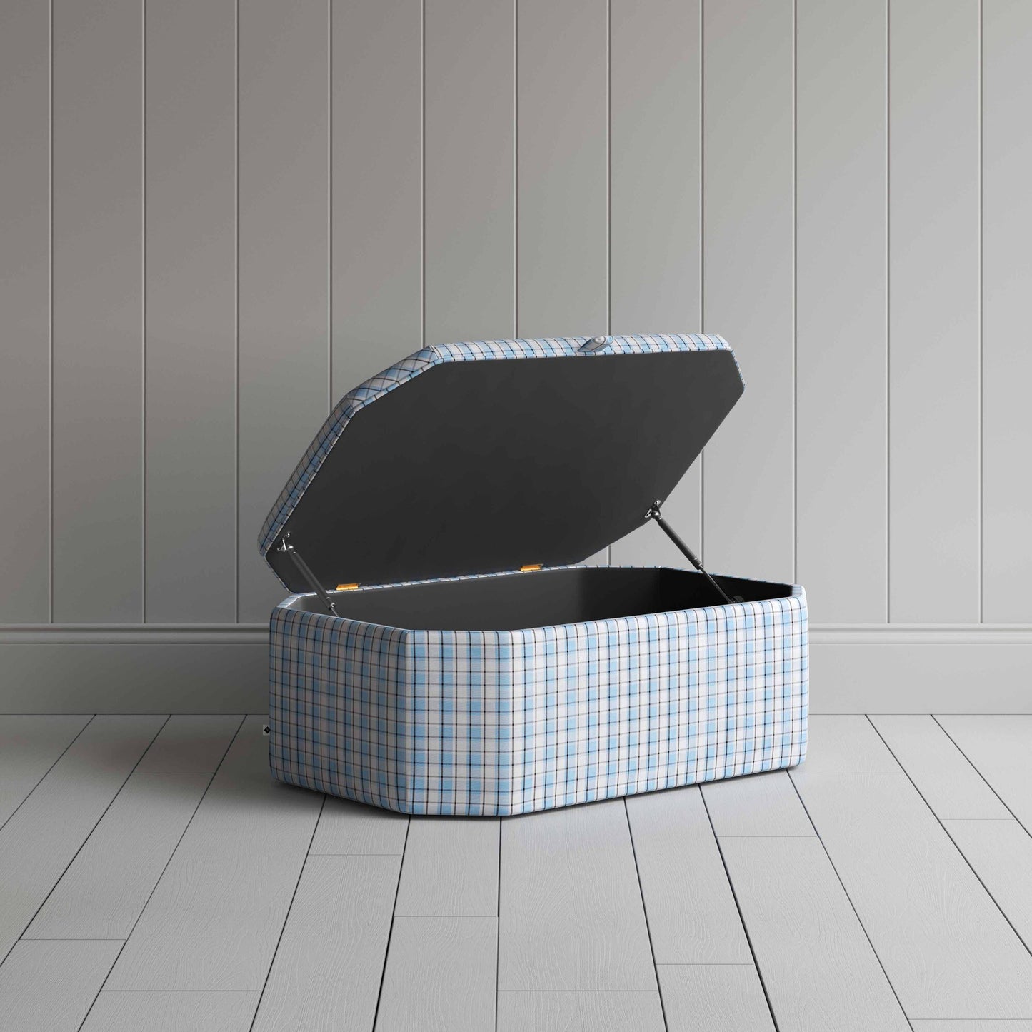 Blue and white checkered ottoman on wooden floor.