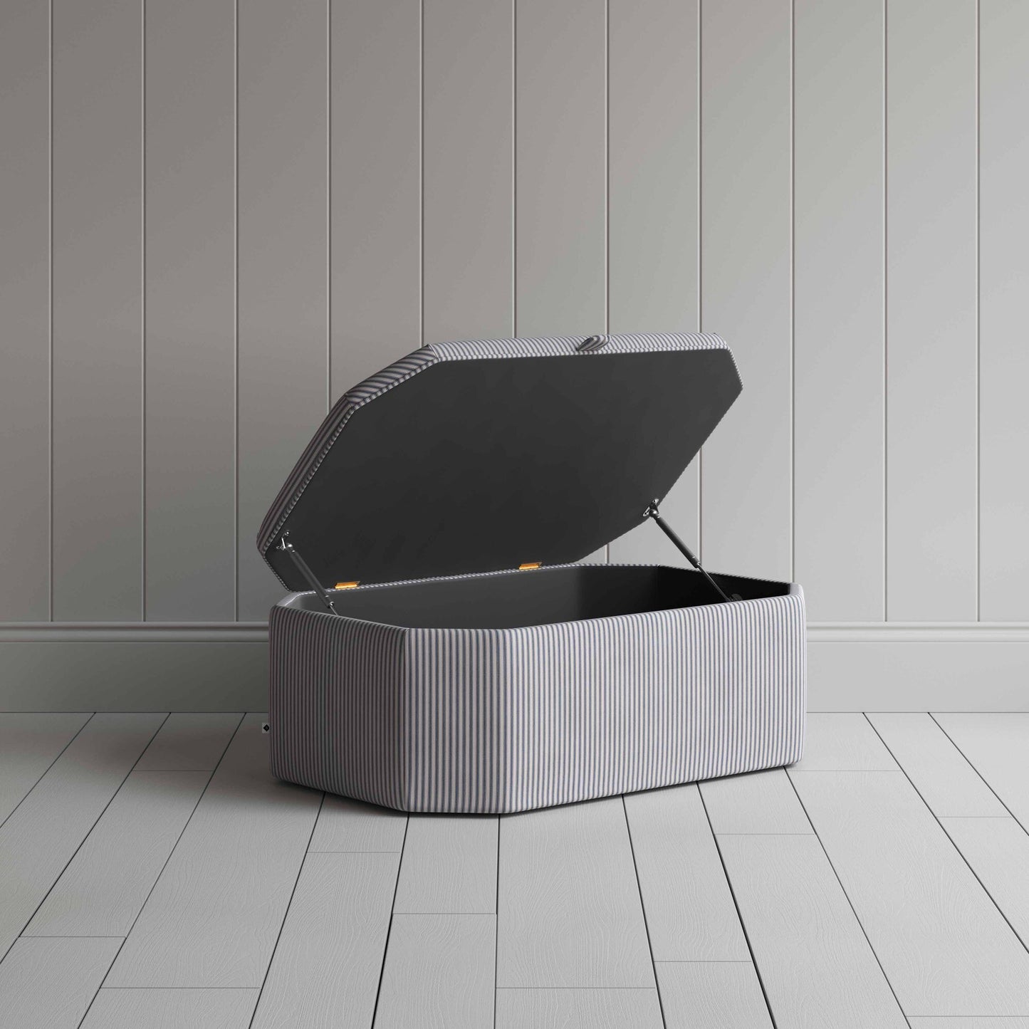 Stylish grey ottoman against white flooring.