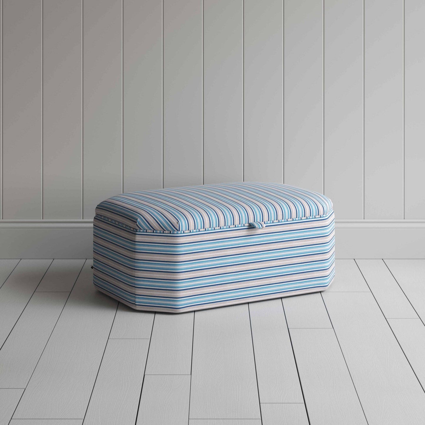 Blue and white striped ottoman on wooden floor.