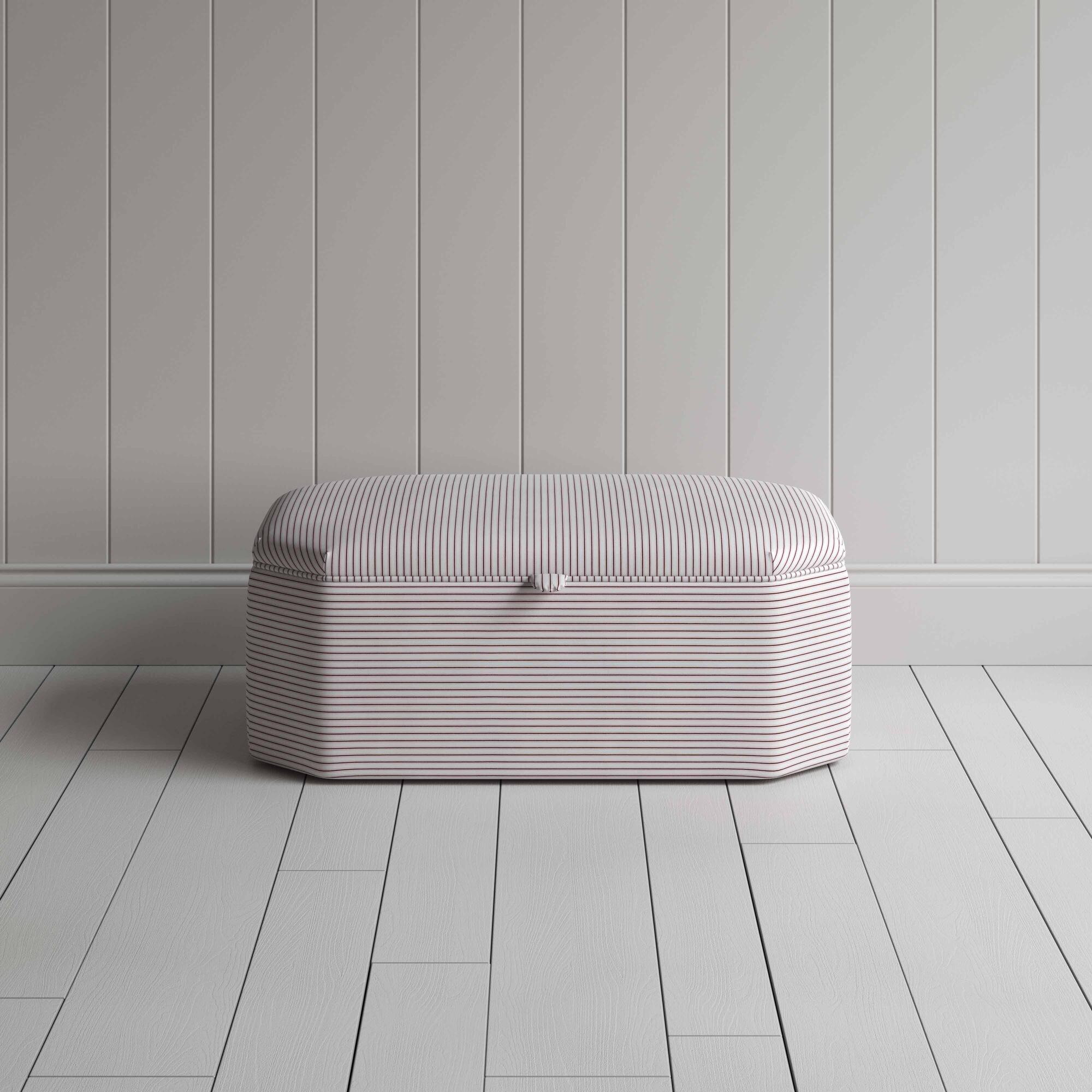  Stylish striped ottoman against white flooring. 