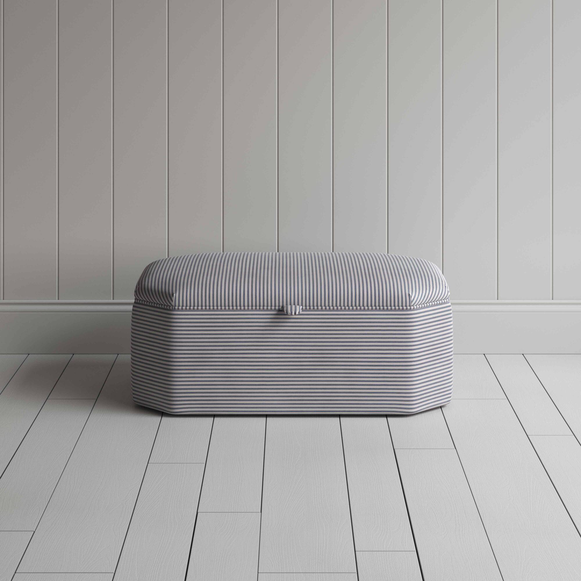  Stylish grey ottoman against white flooring. 